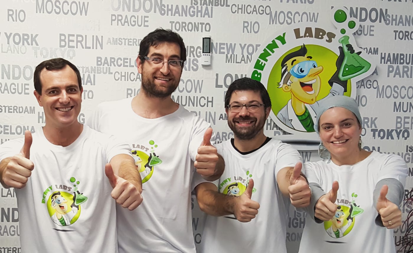 The Benny Labs team giving a thumbs up in front of the Benny Labs mascot